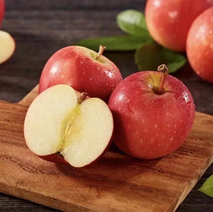 Apple grading machine sorting fresh apples by weight and quality in a modern packing house